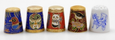 A group of Chinese cloisonné enamel, painted, jade and other thimbles, contained in a wooden wall mounted case. (16) - 2