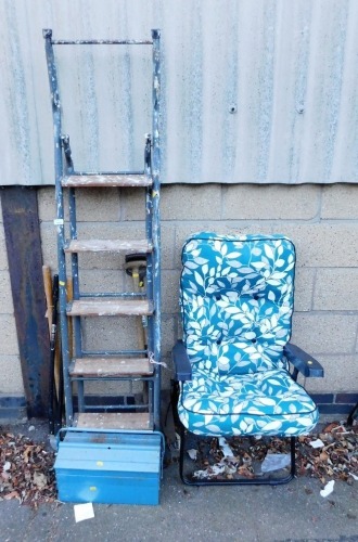 A metal tool box, various garden tools, garden seat with teal leaf pattern upholstery, metal and wooden step ladder, etc. (a quantity)