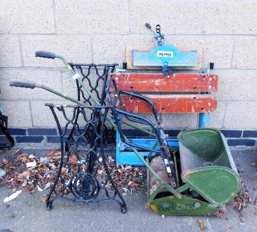 A Clarke work bench, a cast iron sewing machine base, and a mid 20thC JP Maxees lawn mower.