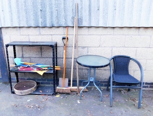 A garden table and two chairs, the table with a tempered glass top, various umbrellas, garden brushes, metal racking, etc. (a quantity)