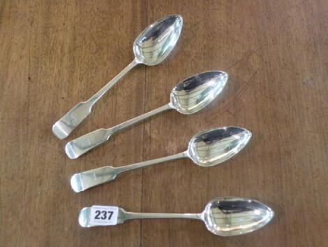 A set of four George IV silver fiddle pattern dessert spoons