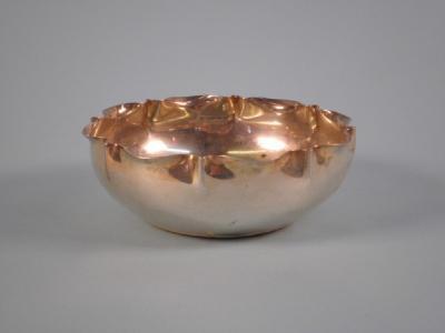 A silver sugar bowl with a shaped border