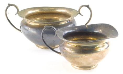 An early 20thC Irish silver part tea service, by T Weir and Sons, comprising of a two handled sugar bowl and jug of bellied circular form with ear handle on circular foot, Dublin 1913, 9cm high, 15½oz.