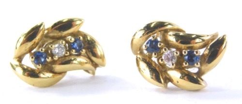 A pair of 18ct gold earrings, each with three section stone set centre with two sapphires and one diamond, a claw outer leaf design on single pin back, lacking butterfly backs, 3.3g all in, boxed.