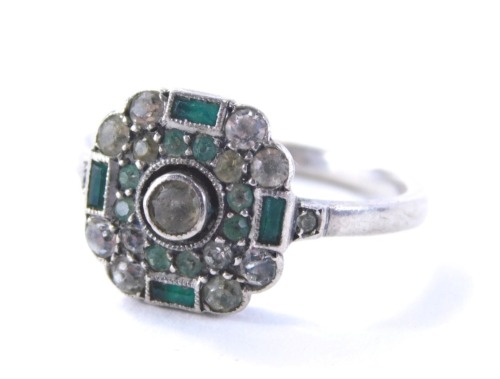 An Art Deco style dress ring, the panelled ring head set with green and white paste stones, on a white metal band unmarked, ring size L½, 2.8g all in.