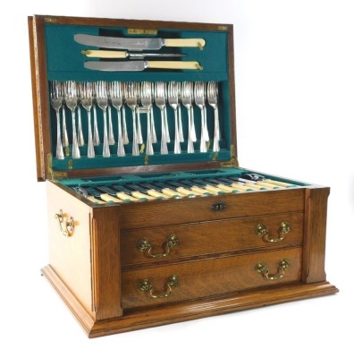 An early 1900 oak cased canteen of cutlery, containing James Deakin & Sons plated flatware, old English pattern to include, bone handled knives, part carving set, settings for twelve, in an oak cased canteen, 29cm high, 52cm wide, 38cm deep.