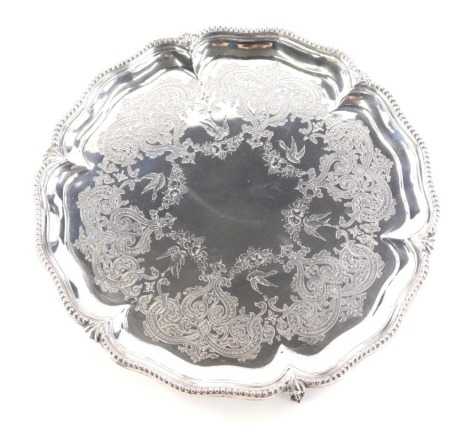 A Victorian silver waiter, of piecrust form with a beaded outline etched interior on claw and ball feet, Goldsmiths and Silversmiths makers mark beneath, London 1873, 26cm wide, 20oz.