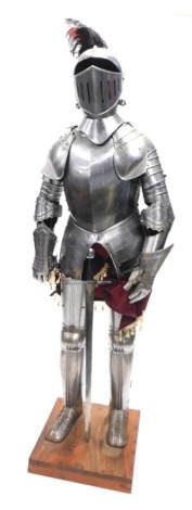 A replica suit of armour, on a hardwood plinth, 193cm high.