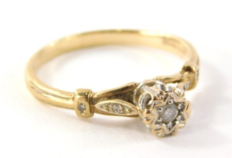 A 9ct gold diamond solitaire ring, on a raised setting with central stone approx. 0.10ct in an illusion oval setting with two tiny diamonds set shoulders, ring size U, 2.6g all in.