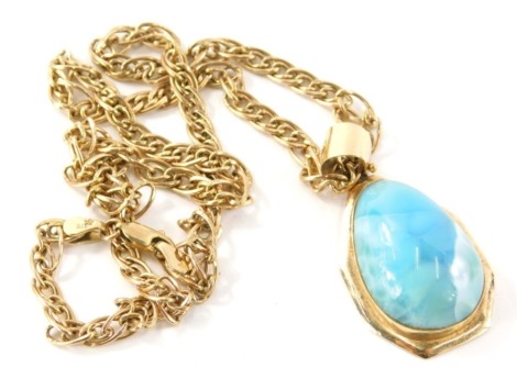 A turquoise set pendant and chain, the egg shaped turquoise set pendant in a yellow metal frame stamped 14K, 4cm high, on a yellow metal multi link chain, 44cm long, yellow metal stamped 375, 17.2g all in.