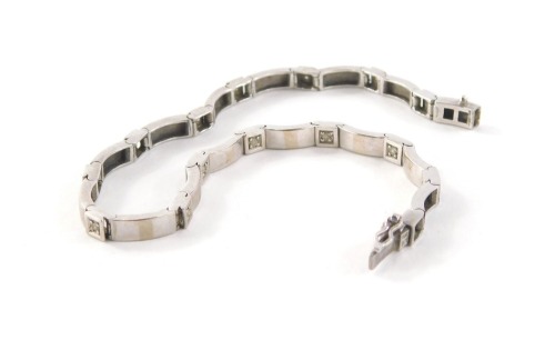 A 9ct white gold diamond set line bracelet, with fifteen illusion set round brilliant cut diamonds and polished links, 19.5cm long, 9.6g all in.