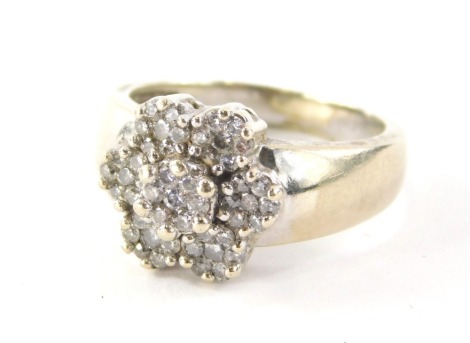 A diamond cluster ring, with six petal flower design, each set with seven round brilliant cut tiny diamonds in claw setting on a white metal band, marked EFFY, 14k, ring size R½, 8.9g all in.