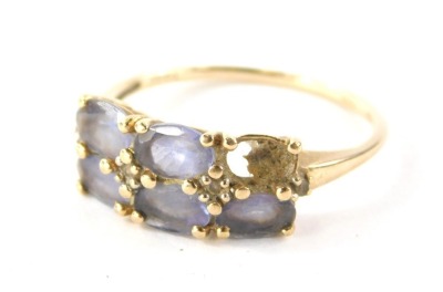 A 9ct gold amethyst dress ring, set with six oval amethysts (1 missing), in claw setting with tiny cz set shoulders, the band fully hallmarked 375 and also stamped 10k, ring size U, 2.5g all in.