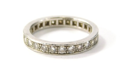 An 18ct white gold diamond eternity ring, set with around twenty eight round brilliant cut stones in claw setting, ring size L½, 4.6g all in, in a Ritz Fine Jewellery of London box.