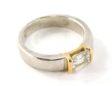 A diamond set dress ring, the central asher cut diamond in a gold coloured tension setting, 6.2mm x 4.8mm x 3mm, on a plain yellow gold band, unmarked but believed to be 18ct, ring size L½, 8.3g all in.