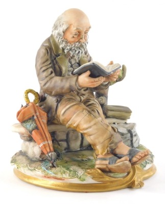 A 20thC Capodimonte figure, of an elderly gentleman on a wall reading aside umbrella, satchel and book on gilt line scroll base, marked beneath, 24cm high.