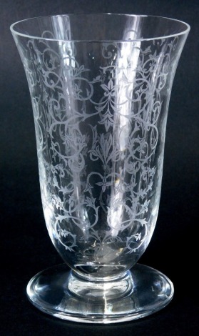 A Baccarat glass vase, of bell shaped form, decorated with a repeat scroll floral pattern on a plain foot, marked beneath, 17cm high.