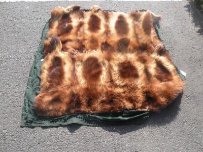 An animal skin rug composed of eight pelts