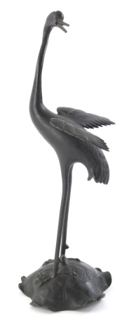 A Japanese Meiji bronzed metal figure of a heron, on a shaped base, 34cm high.