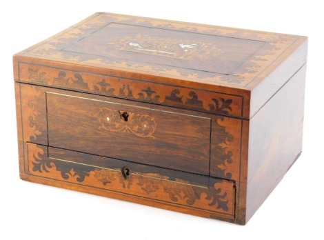 A 19thC rosewood travelling vanity box, of rectangular form, the centre inlaid with an outer floral decoration and inset with mother of pearl birds and trees, hinging to reveal front drawers and fitted interior, 17cm high, 31cm wide, 22cm deep.