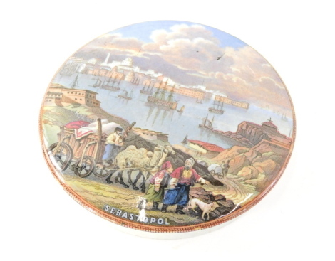 A 19thC Prattware pot lid, Sebastopol, transfer printed polychrome decorated, 12cm diameter.