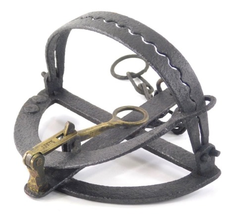 A 19thC iron and brass egg laying trap, of shaped form, with H Lane maker stamp, 22cm wide.