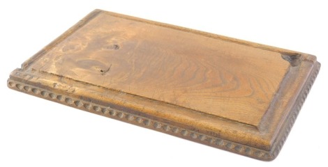 A 19thC elm chopping block, of rectangular form, with shaped outline possibly French, 40cm wide.