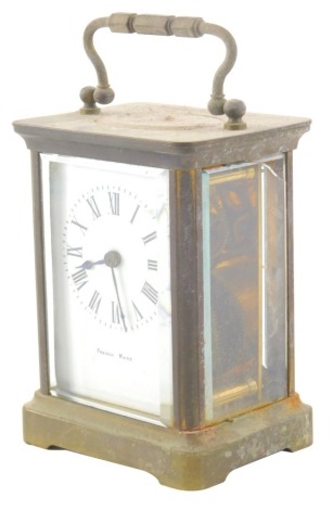 An early 20thC French brass carriage clock, of rectangular form, in a five part glazed case, with 5cm wide Roman numeric dial, visible movement and key, 12cm high.