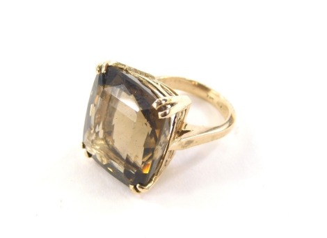 A smokey quartz dress ring, with rectangular cut smokey quartz, measuring 20mm x 17.5mm x 11.5mm, in double claw raised basket setting, on a yellow metal band, unmarked, ring size L, believed to be 9ct gold, 12.9g all in.