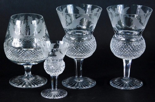 Four Edinburgh crystal drinking glasses, to include brandy balloon, 12cm high, etched with thistle with a hobnail cut centre, marked beneath, etc. (4)