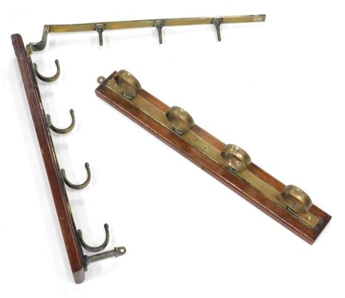 A pair of early 20thC oak and brass articulated wall hangers.