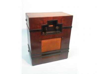 An Art Deco style radio in a figured walnut case with bakelite fittings