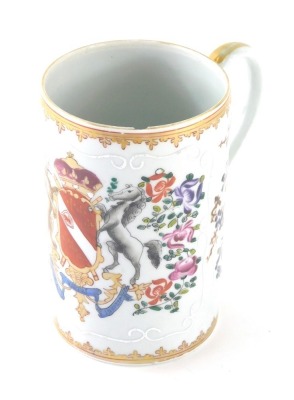 A 19thC Samson Paris porcelain tankard, of cylindrical form, with plain gilt lined handle and armorial crest, hand painted with flowers in famille rose colours, on a circular foot, faux oriental marks beneath, 15cm high.