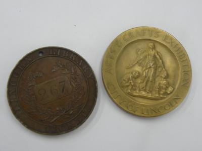 A bronze Lincoln Library ticket or token and a medallion from