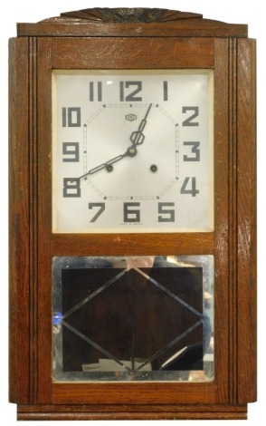 An ODO, French Art Deco wall clock, with silvered dial and verre eglomeese panel, 58cm high.