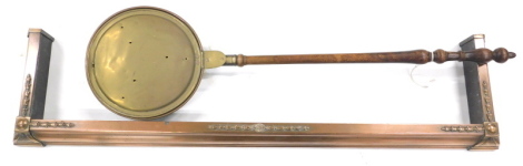 An early 20thC copper fire curb, in Adams style, 130cm wide, and a brass and copper warming pan with turned wooden handle.