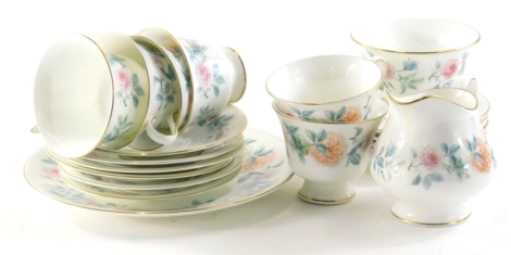 A Wedgwood Mist Rose part tea service comprising service plate, 24cm diameter, cups, saucers, side plated, milk jug and sugar bowl, settings for six, printed marks beneath. (a quantity)