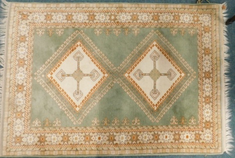 A 20thC rug, of rectangular form centred by diamond with a geometric outer field, 188cm x 122cm.