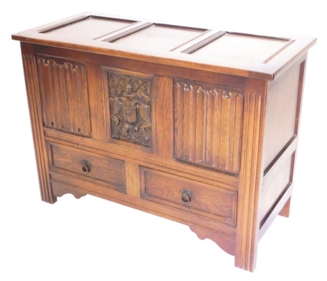 A carved oak mule chest, with panelled top above a frieze carved with linen folds and a crest above two drawers on styles, 100cm wide.