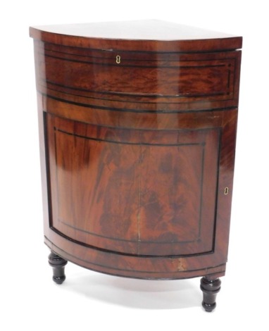 A mahogany and ebony strung standing corner cabinet, with single panelled door on turned legs, 95cm high, 69cm wide.