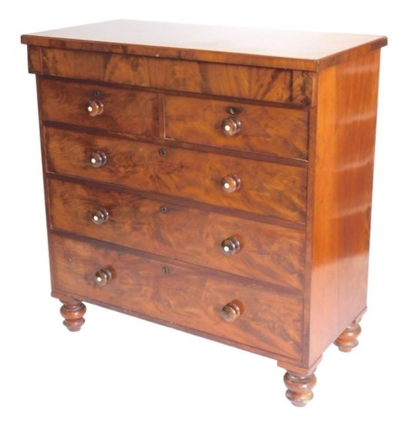 A Victorian figured mahogany chest of drawers, with an arrangement of one long frieze drawer above two short and three long drawers, each with turned handles on turned feet, 114cm wide.