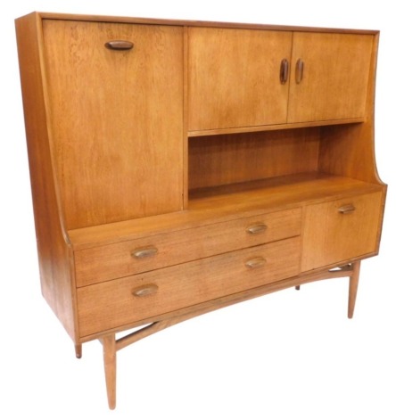 A G Plan side board or dresser, with an arrangement of one large and two small doors, the base with a further two drawers and a full front door, on turned tapering legs, 136cm high x 152cm wide. (AF)