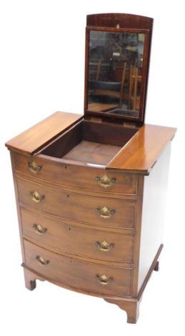 A mahogany bow fronted dressing chest, the triple hinged top enclosing a mirror and a recess above a false draw and three further drawers each with pierced brass drop handles on bracket feet, 61cm wide.