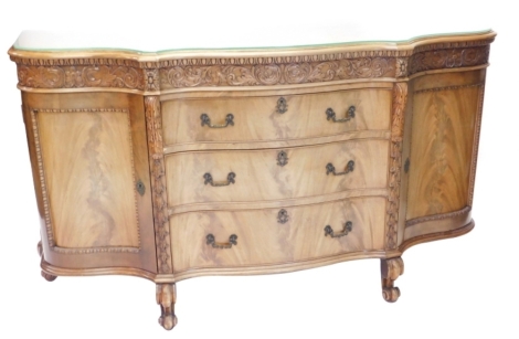 A continental mahogany sideboard, the shaped top with a moulded edge above a frieze carved with flowers, scrolls and leaves and three drawers each with cast handles flagged by two panelled doors each with beaded borders on scroll feet, 95cm high, 168cm wi