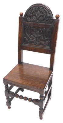 A 17thC and later oak side chair, the back carved with stylised tulips, etc., with a later solid seat on bobbin turned supports.