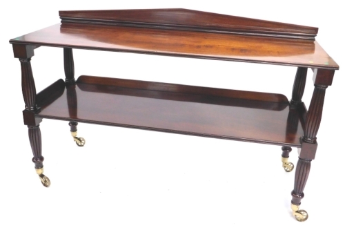 An early Victorian mahogany two tier buffet, with a raised panelled back, each tier with a channelled edge on turned and reeded supports with spoked brass casters, 105cm high, 168cm wide, 60cm deep. Provenance; The property of a Lady. Purchased from Stair