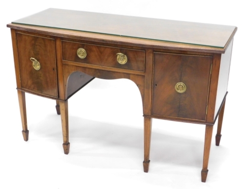 A small mahogany bow fronted sideboard, in George III style, the top with a reeded edge above a frieze drawer, flanked by two doors on square tapering legs with splayed feet, 77cm high, 122cm wide, 51cm deep.