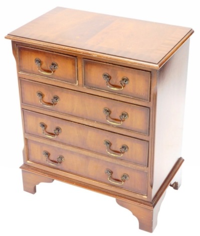 A mahogany small chest of drawers, the cross banded top with a moulded edge with two short and three long drawers, each with brass handles on bracket feet, 62cm wide.