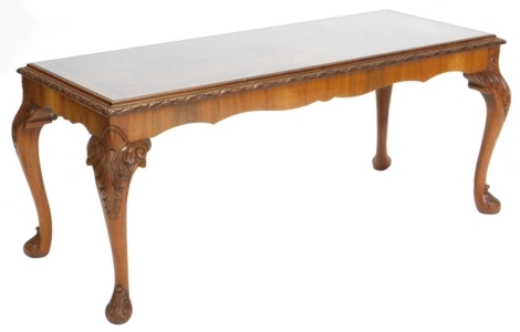 A 20thC walnut coffee table, of rectangular form with heavily carved cabriole legs.