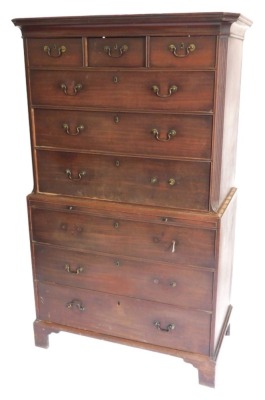 A George III mahogany chest on chest, the top with a moulded canted cornice above three short and three long drawers each with brass handles flanked by canted corners, the base with a brushing slide and three further drawers on bracket feet, 183cm high, 1